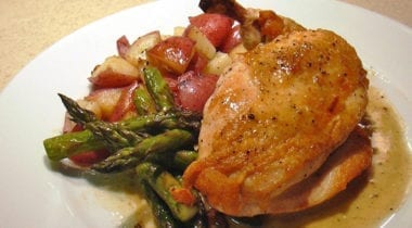 half side of roasted chicken with asparagus and red potatoes