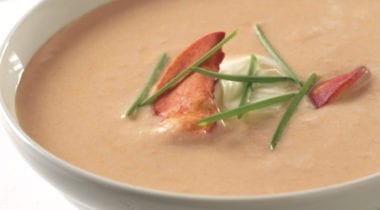 lobster bisque in a bowl with garnish