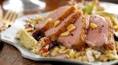 sliced duck breast on plate of food