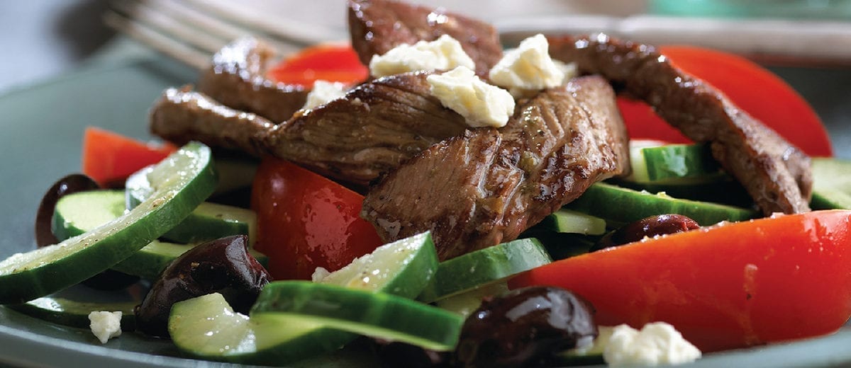 salad with steak, tomatoes and cheese crumbles