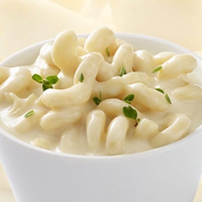 cavatappi pasta with white cheddar cheese sauce in dish