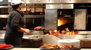 man grilling in restaurant kitchen