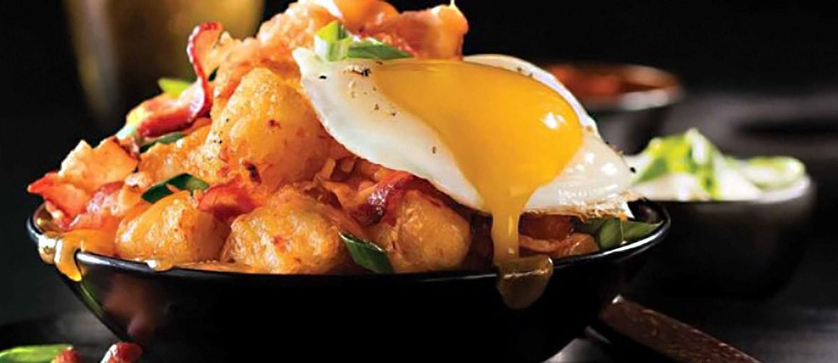 tater tots topped with bacon and eggs