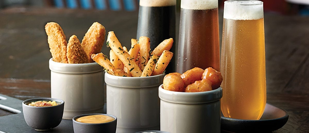 fried appetizers with glasses of beer