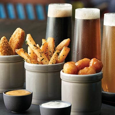 fried appetizers with glasses of beer