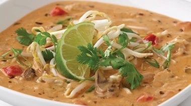 creamy thai soup topped with lime and garnish