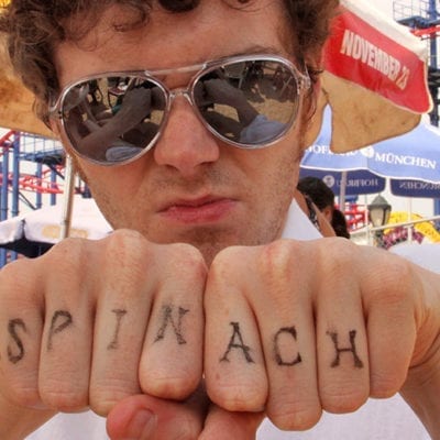 man with spinach written across his knuckles