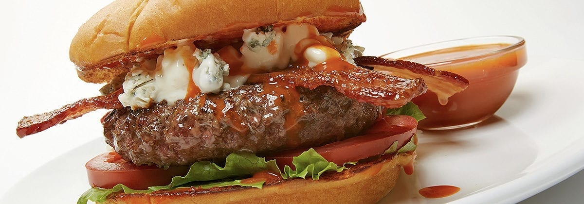 cheeseburger with bacon, lettuce tomato, bleu cheese and buffalo sauce