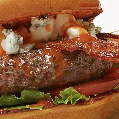 cheeseburger with bacon, lettuce tomato, bleu cheese and buffalo sauce