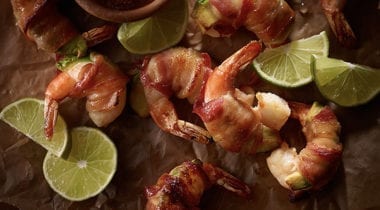 bacon wrapped shrimp with lime slices