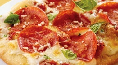 pepperoni pizza with basil and grated parmesan