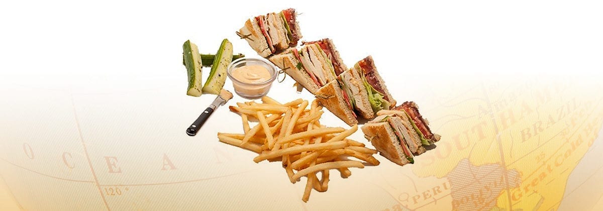 chicken club sandwich with fries and pickles