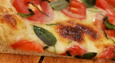 cheese, tomato and basil pizza slice