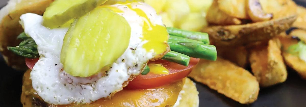 chicken burger with pickles, eggs and fries