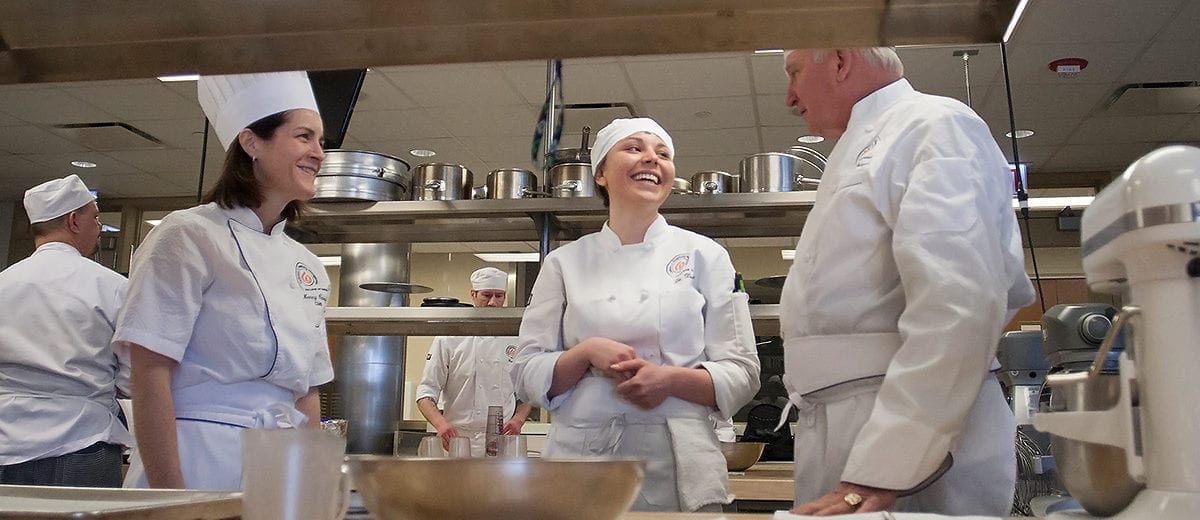 3 chefs in kitchen talking