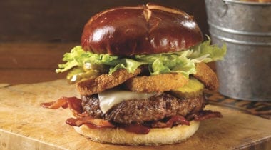 rodeo burger with onion rings on it
