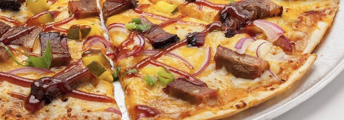 thin crust pizza with meat and jalapenos