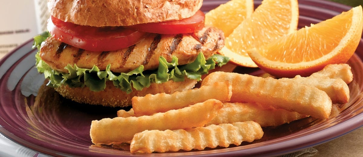 french fries and chicken sandwich lemon wedges