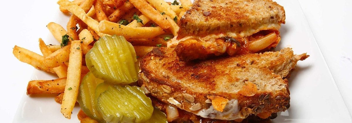 sriracha grilled cheese sandwich with pickles and fries