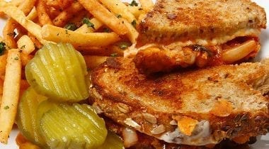 sriracha grilled cheese sandwich with pickles and fries