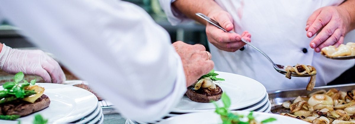 chefs finishing a dish