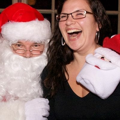 woman laughing on santa's lap