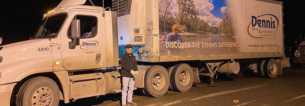 man in front of tractor trailer