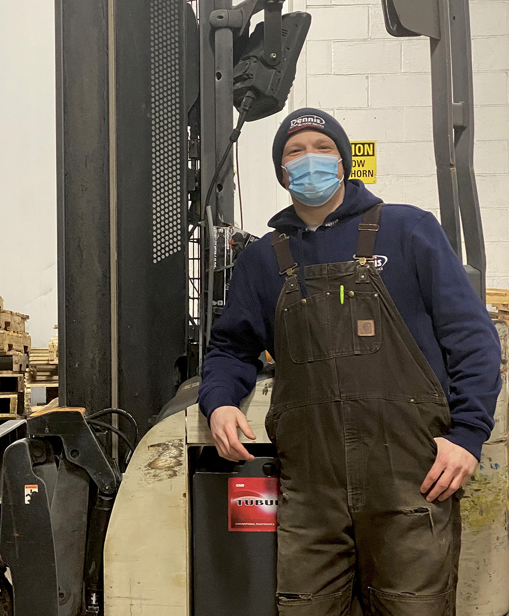 man standing by forklift with mask