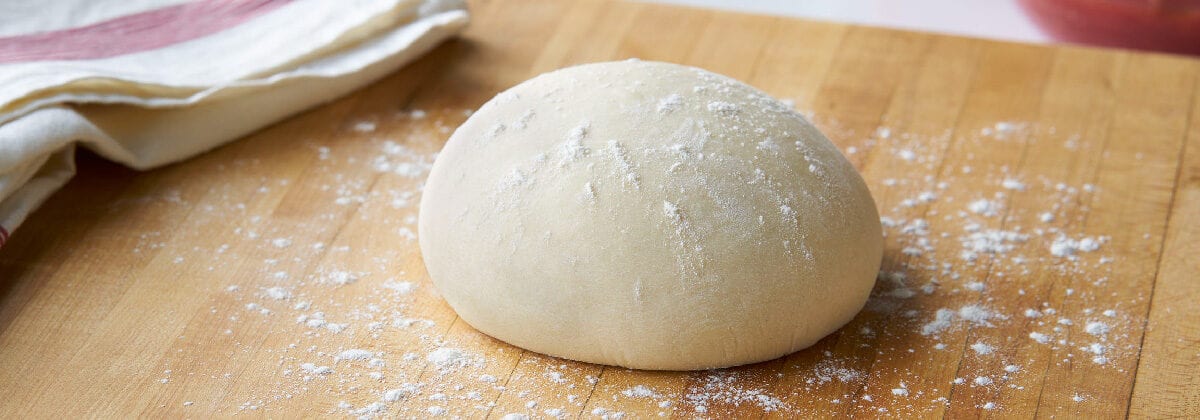 pizza dough ball with flour