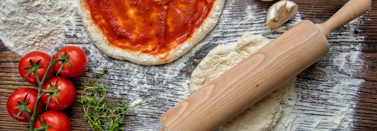 pizza dough, sauce on dough, rolling pin