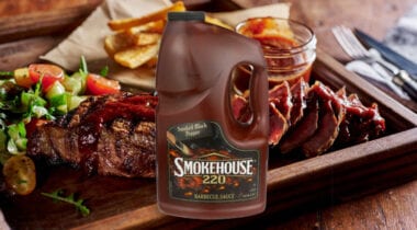Smokehouse BBQ sauce with barbecue meat background