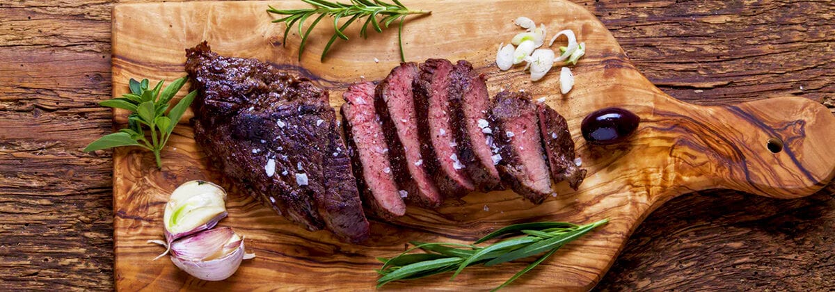 teres steak sliced on cutting board with seasonings