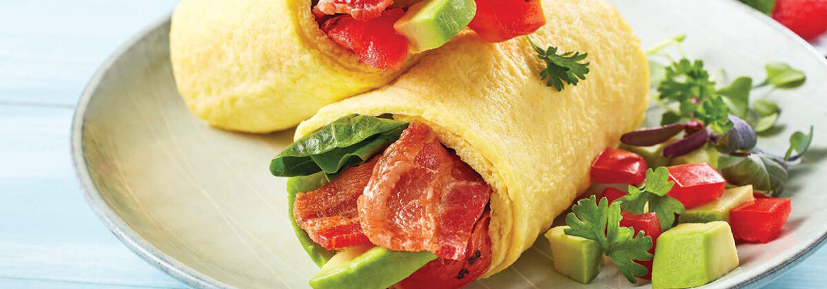Breakfast bacon, lettuce, avocado and tomato in egg wrap