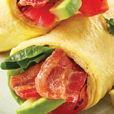 Breakfast bacon, lettuce, avocado and tomato in egg wrap