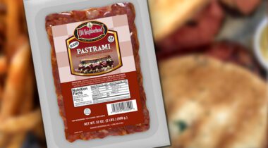 old neighborhood red sliced pastrami in package over blurred sandwich