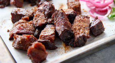 cooked beef brisket burnt ends on white plate