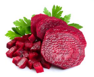 sliced red beets with parsley leafs on white background