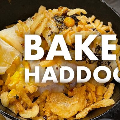 mini sized skillet with baked haddock and lemon slice. Words Baked Haddock over food