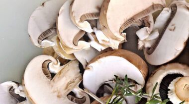 slices of mushrooms with twig of rosemary