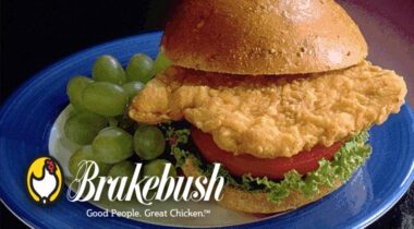 blue plate with chicken sandwich and grapes with Brakebush logo over graphic