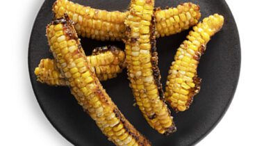 bbq corn pieces on black plate