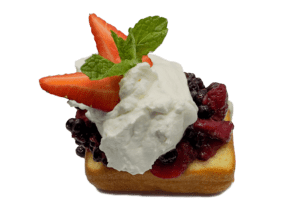 simple joys lemon cake with fresh berries, whip cream, cut strawberry and mint