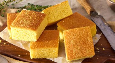 square cut pieces of baked cornbread on wood cutting board