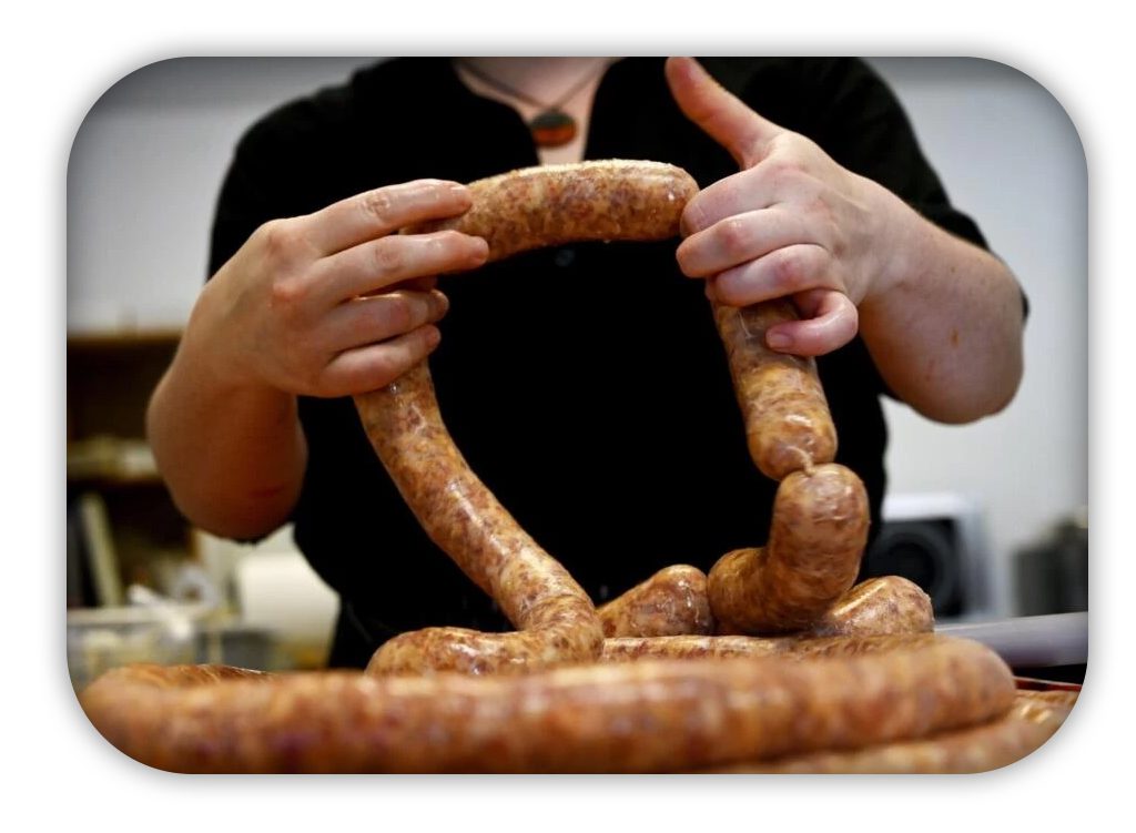 hands working with fresh sausage links