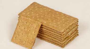 stack of graham crackers with half a cracker leaned up against stack