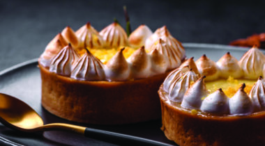 Black plate with two lemon tartlets