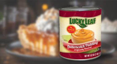 Can of Lucky Leaf Butterscotch Pudding over blurry photo of pie