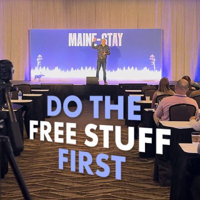do the free stuff first graphic, man on stage, words
