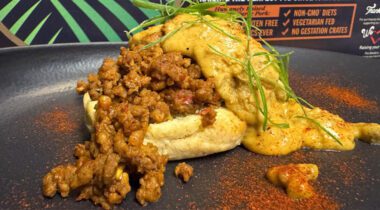 Chorizo sausage crumbles on an English muffin with a gravy sauce