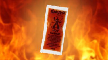 hot sauce packet in front of flames